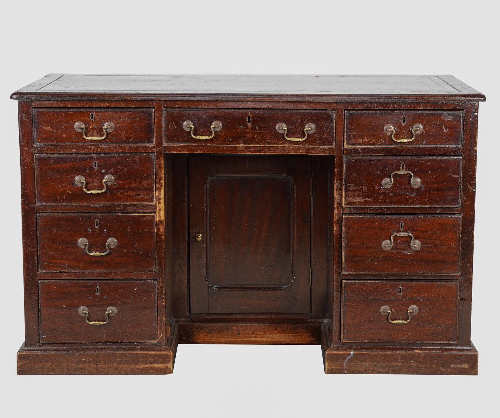 GEORGIAN OAK DOUBLE-PEDESTAL DESK: with gilt-tooled leather-inset writing surface; Condition: hardware replaced and later; leather with losses and marks and probably a later replacement; cracks, scratches, gouges and incised ring-shape