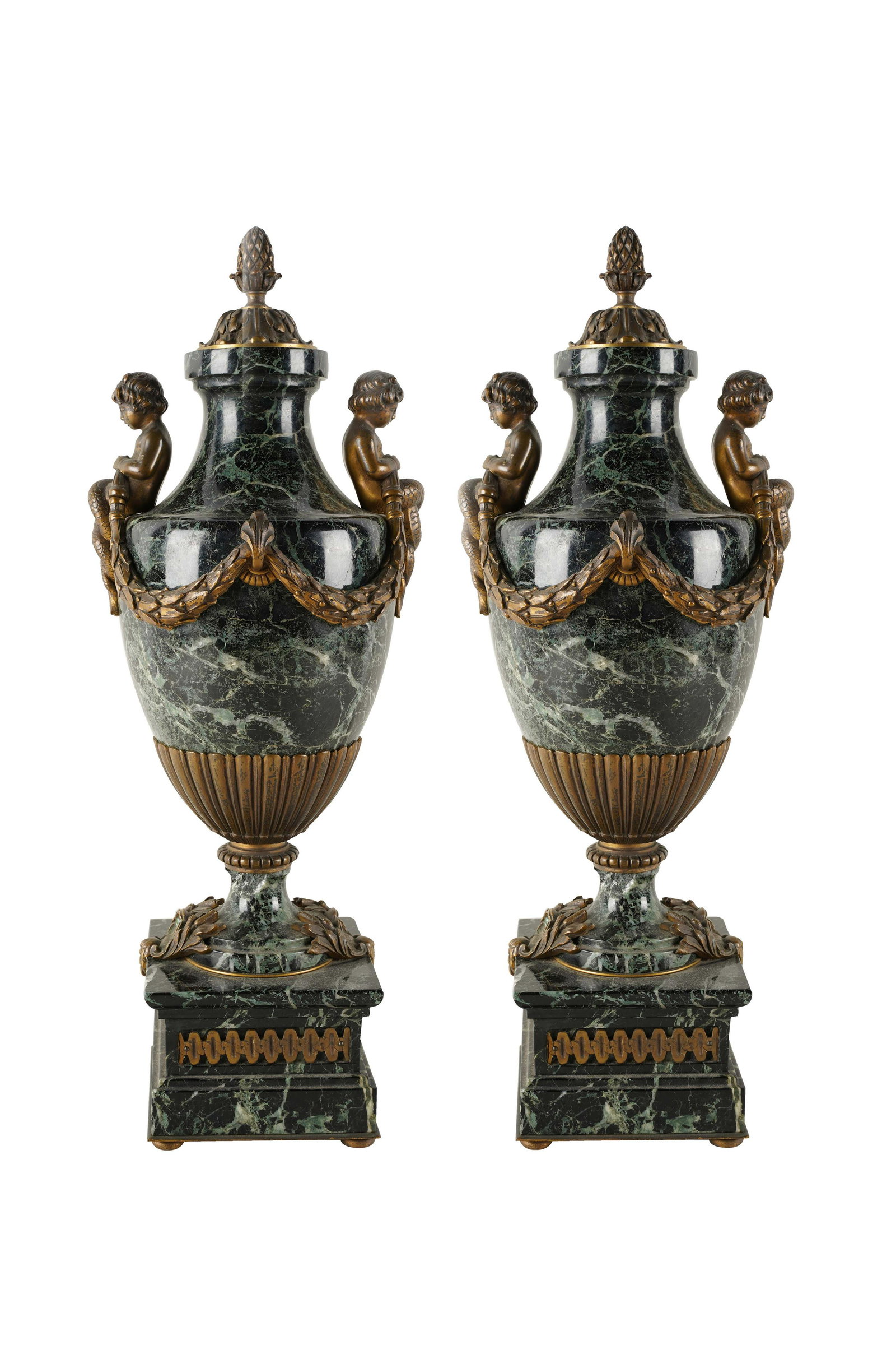 PAIR OF BRONZE-MOUNTED GREEN MARBLE URS: in the Louis XVI style, wiith figural mounts suspending laurel garlands; Condition: each with fleabites along edges of plinths; 7 1/4 inches wide; 19 1/2 inches high