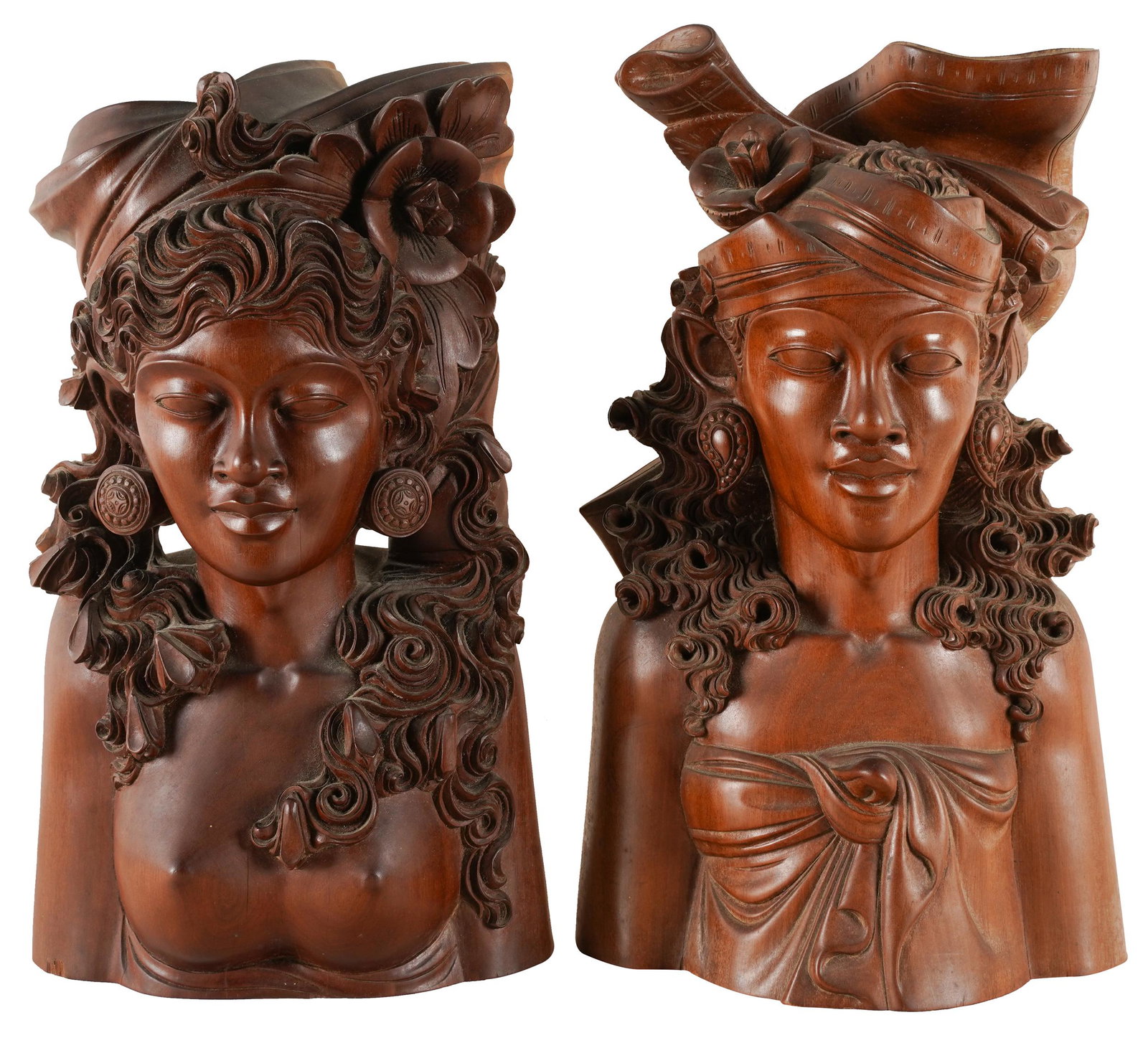 PAIR OF BALINESE CARVED WOOD BUSTS: depicting two women; the taller: 13 inches high
