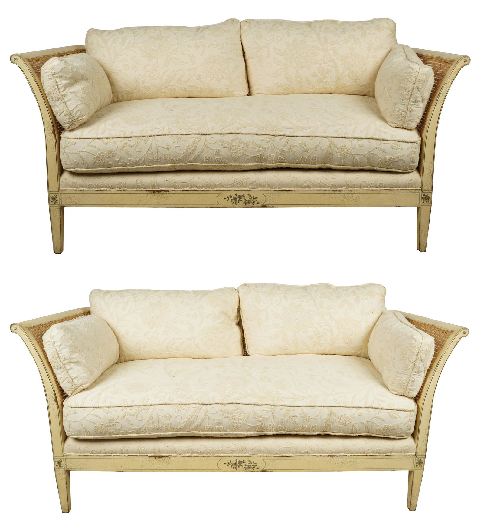 PAIR OF NEOCLASSIC PAINTED WOOD & CANE SETTEES: late 20th century; the cushions covered in off-white embroidered linen fabric; Condition: finish intentionally crackled and distressed; 72 inches wide; 33 inches deep; 33 inches high