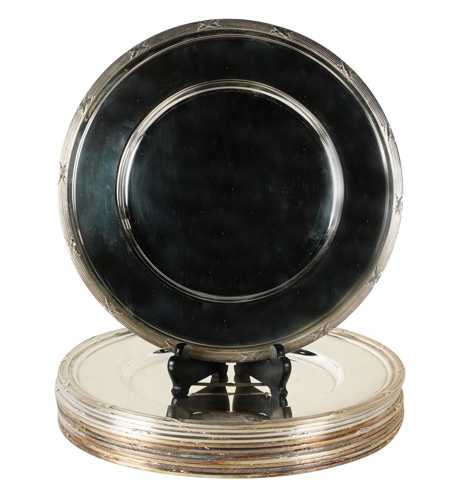TWELVE SILVERPLATE CHARGERS: stamped 'TCP Ld' below; Provenance: The Estate of Barry Tarlow, Los Angeles; Condition: with knife marks across surface of some plates and oxidation; 12 inches diameter