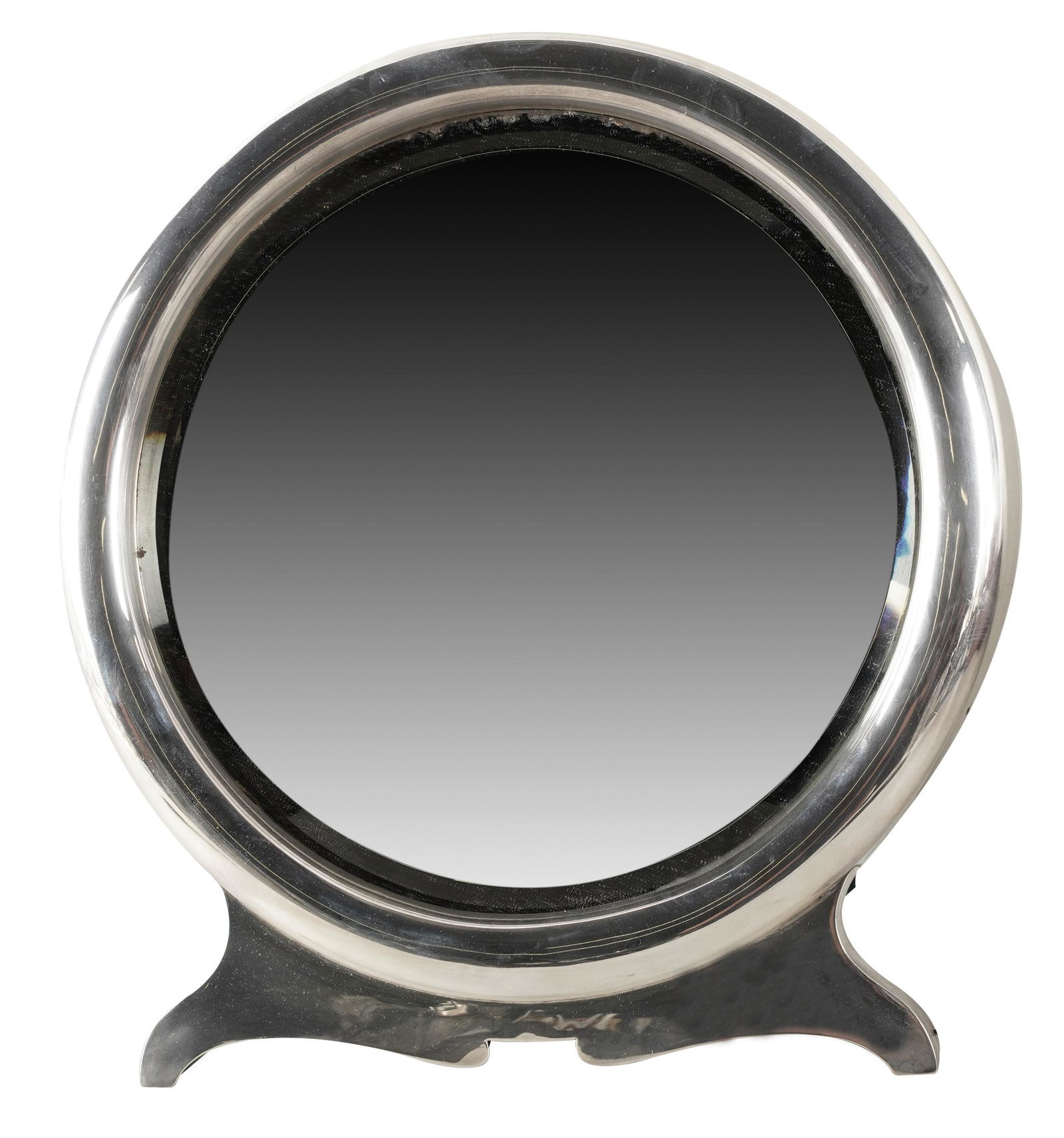 EDWARDIAN STERLING EASEL-BACK MIRROR: William Comyns & Sons, London, 1901; with beveled mirror plate; the back covered with green velvet; The Estate of Barry Tarlow, Los Angeles; 11 1/2 inches diameter; 6 1/2 inches deep standing