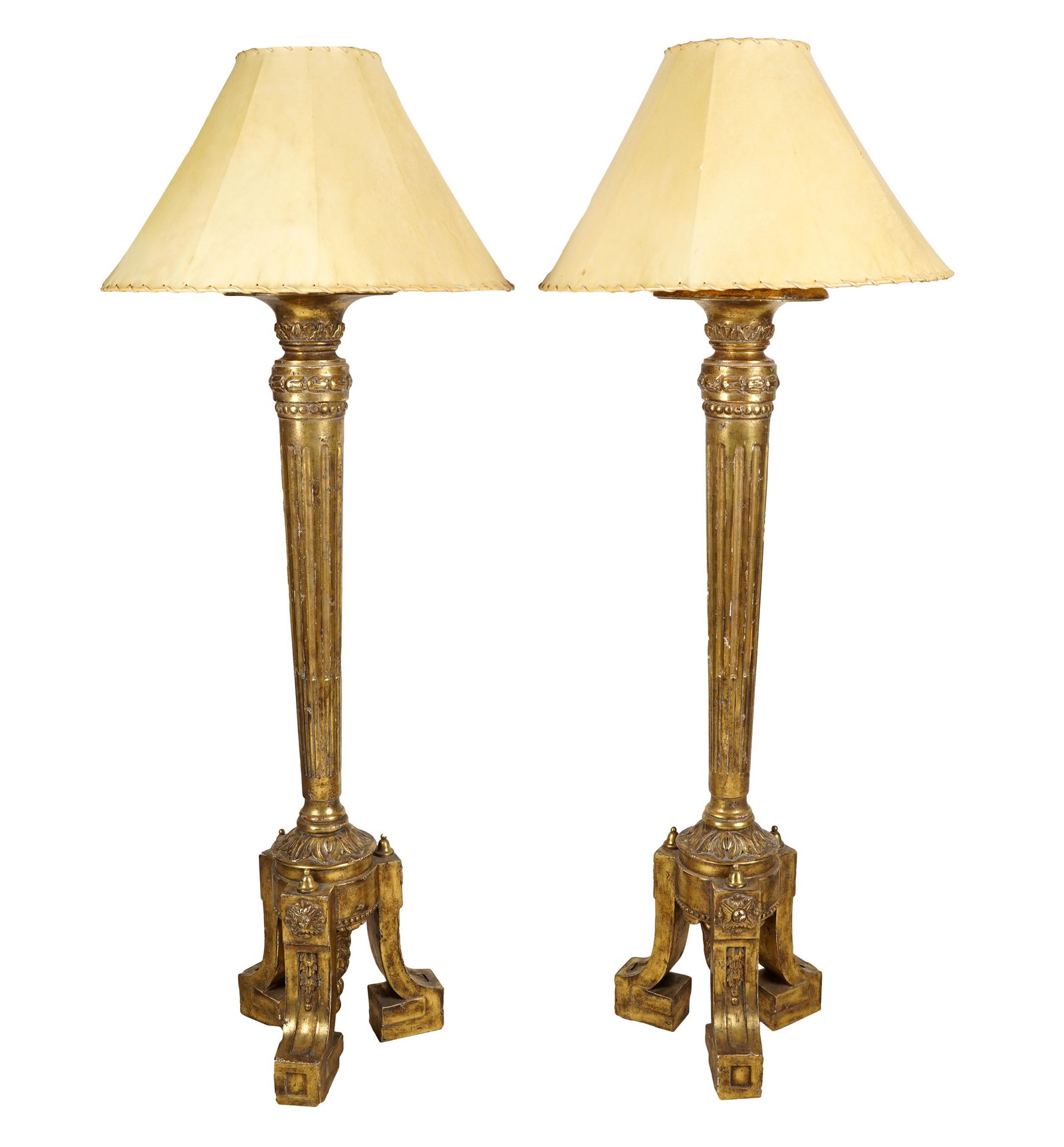 PAIR OF NEOCLASSIC GILTWOOD FLOOR LAMPS: each with a parchment shade and twin socketrs; Condition: one lamp with repair and bent shaft; 48 inches high to top of standard; 62 1/2 total inches high