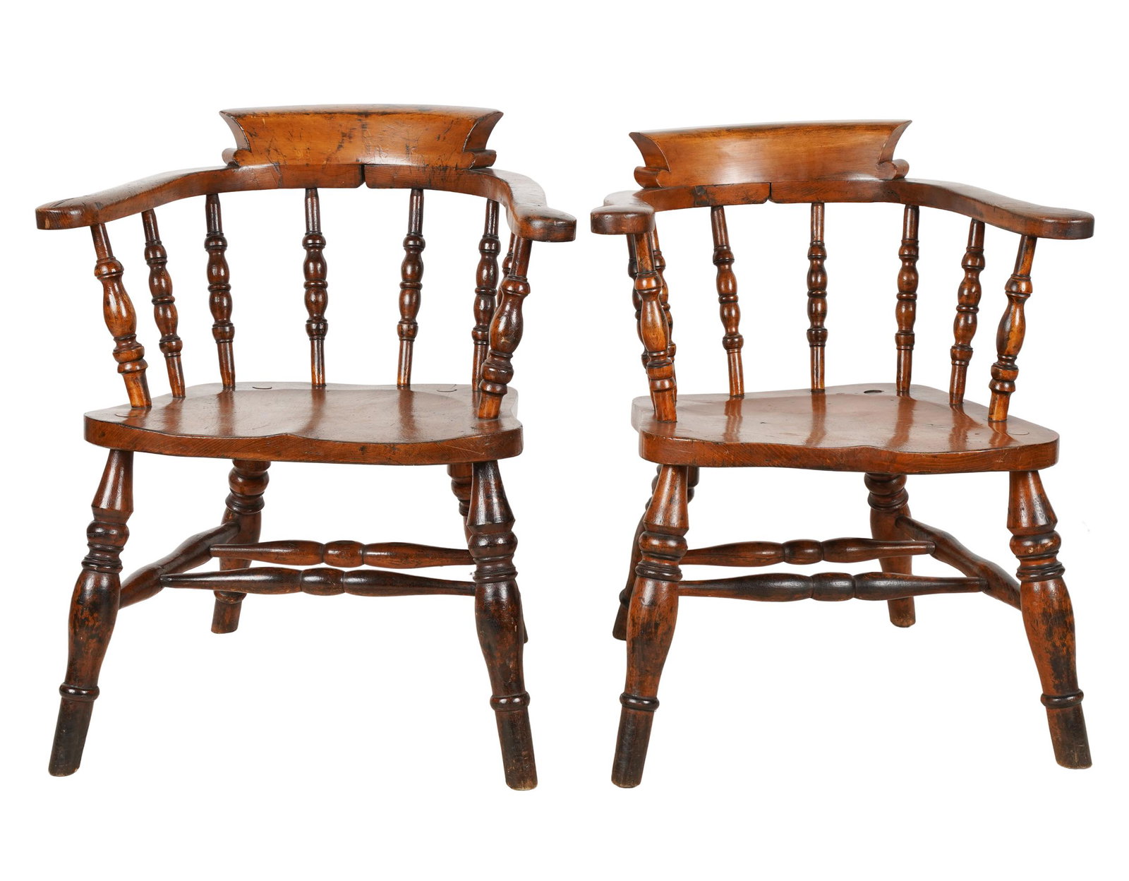 PAIR EDWARDIAN SMOKER'S BOW ARMCHAIRS: each stamped "J. Elliot and Son" to tne rear of the seat; ash, beech, and elm; 24 inches wide; 21 inches deep; 28 1/2 inches high; seat height: 16 1/4 inches