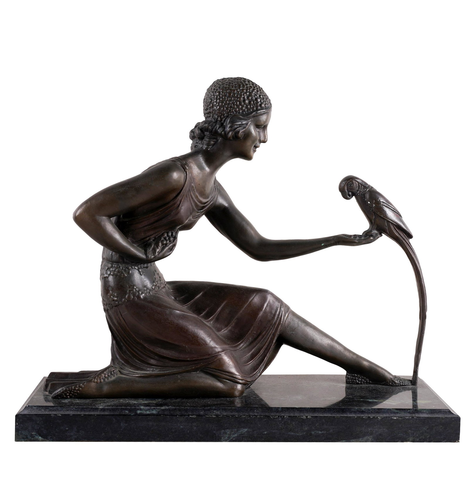 BRONZE FIGURE OF A WOMAN WITH BIRD: signed to base; set atop marble plinth; the bronze: 16 inches wide; 12 inches high; the base: 16 inches wide; 6 inches deep; 1 inch high