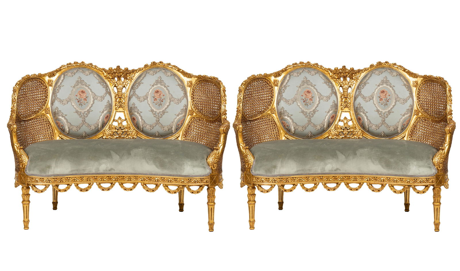 PAIR OF GILT & CANE SETTEES: in the Italian Rococo taste; with double cane sides; 51 1/2 inches wide; 20 inches deep; 38 inches high; seat height: 17 inches