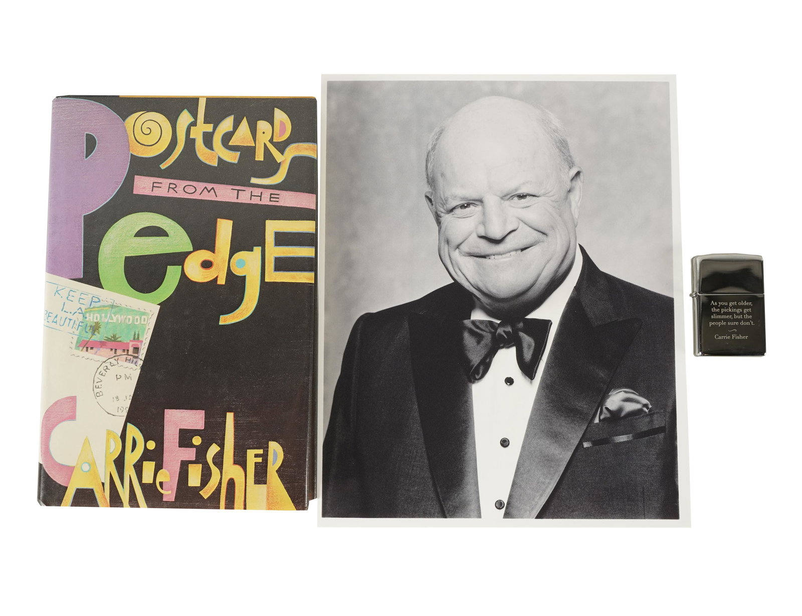 DON RICKLES CARRIE FISHER BOOK & ZIPPO LIGHTER: Postcards from the Edge and a Vanity Fair 2017 Oscar Party gift lighter inscribed "As you get older, the pickings are slimmer, but the people sure don't. / Carrie Fisher" on the side also engraved "VF