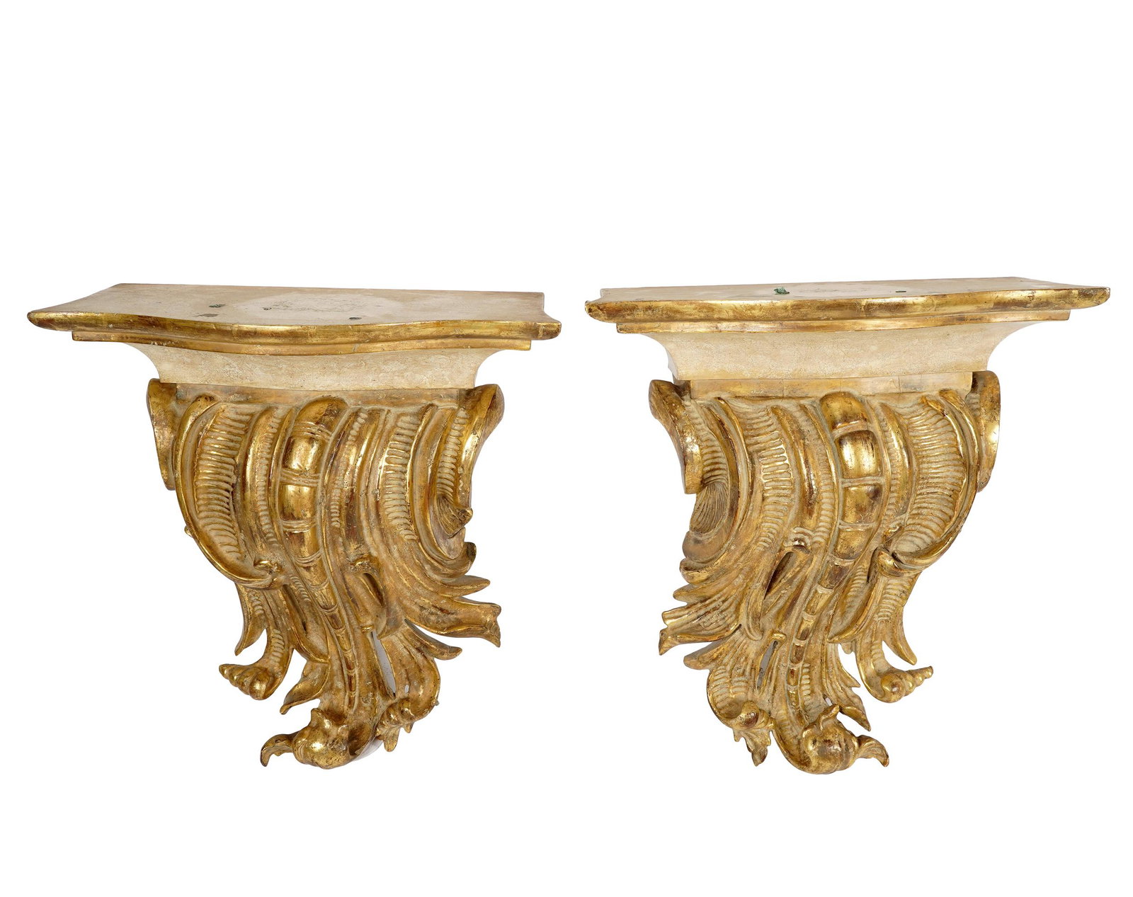 DON RICKLES PAIR OF GILT CORBELS: giltwood and gesso; in the Rococo style; Condition: with chipping to tops and throughout; with bug holes; 22 inches wide; 11 inches deep; 23 inches high