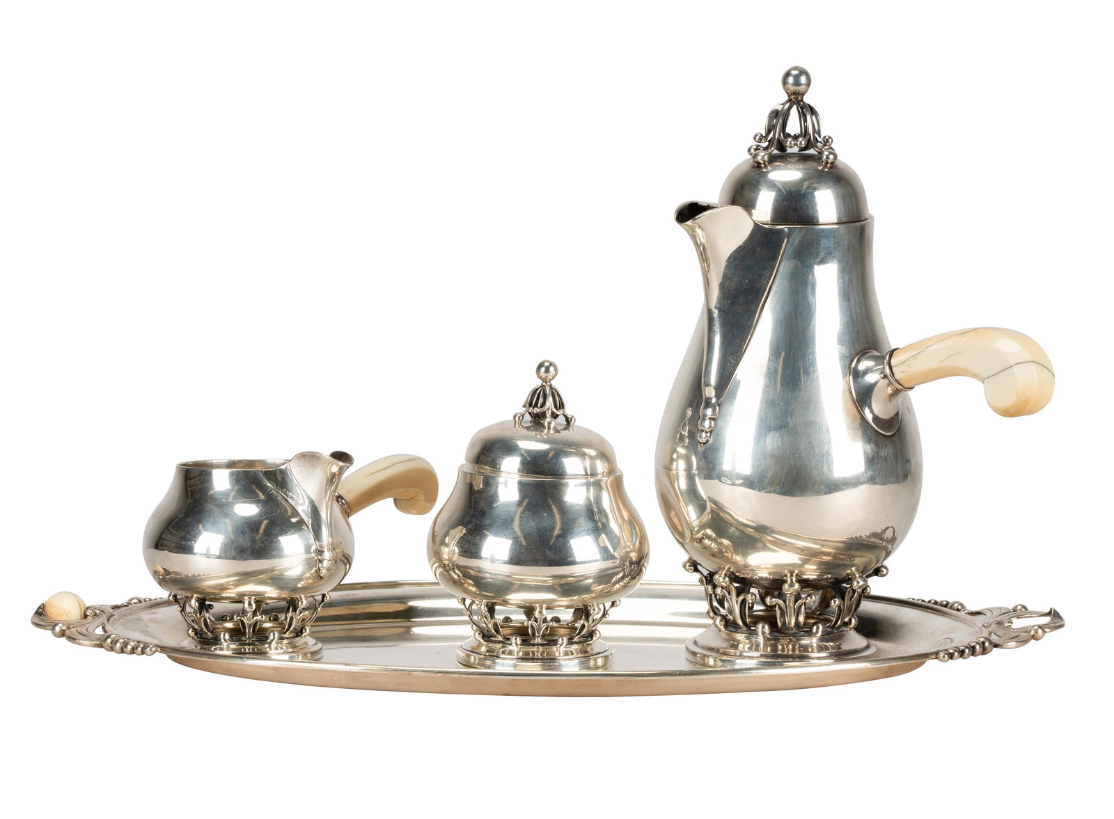 FOUR-PIECE AMERICAN STERLING COFFEE SERVICE: mark of Woodside Sterling Company, further marked "Sterling" and "850"; comprising a coffee pot with bone handle (10 inches high); a covered sugar (5 inches high); a creamer with bone handle; and an o