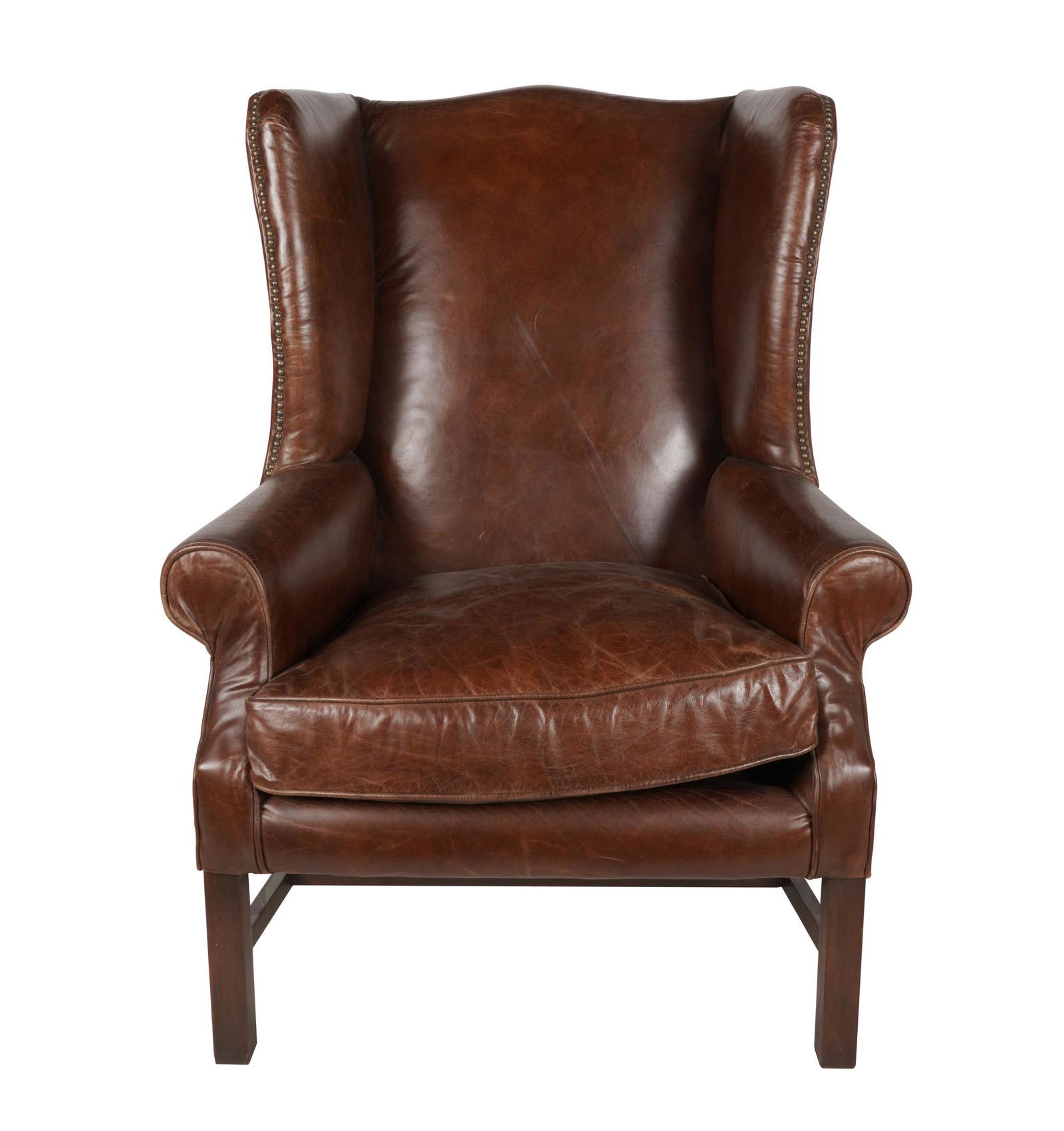 GEORGIAN-STYLE LEATHER WING CHAIR: paper label to underside "Made in China"; Provenance: The Jim Belushi Collection, a Michael Smith Installation; 36 inches wide; 29 inches deep; 48 inches high; seat height: 20 inches