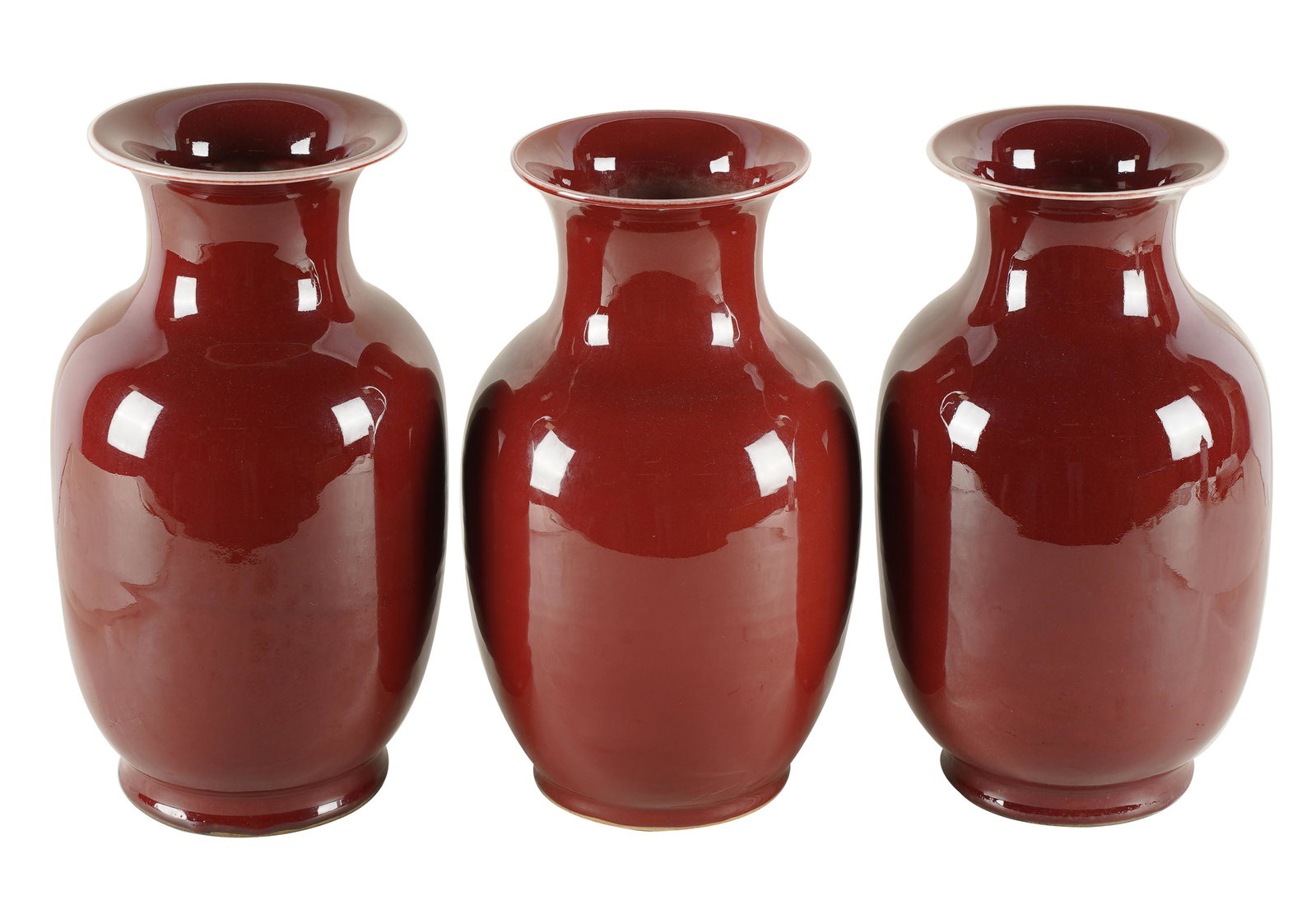 THREE SANG DE BOEUF PORCELAIN VASES: unsigned; Provenance: The Jim Belushi Collection, a Michael Smith Installation; the pair: 12 1/2 inches high; the other:13 inches high