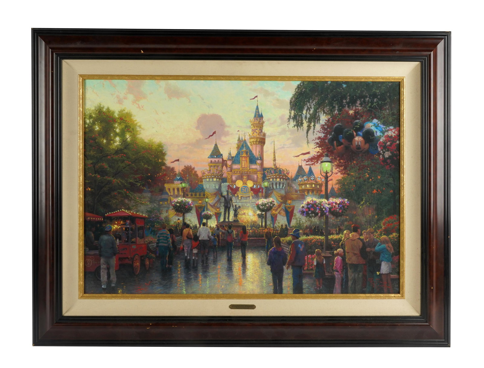 THOMAS KINKADE: DISNEYLAND 50TH ANNIVERSARY: signed lower right; 23 1/2 x 35 1/2 inches sight; 34 1/2 x 46 1/2 inches frame