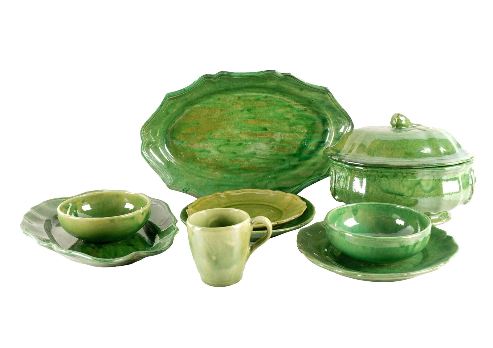GREEN-GLAZED FAIENCE DE BIOT SERVICE: impressed Biot factory mark over "Made in France"; comprising 18 dinner plates (9 3/4" dia.); eight scalloped plates (9 1/4" dia.); 25 scalloped salad plates (8 1/4" dia.); eight scalloped bread plate