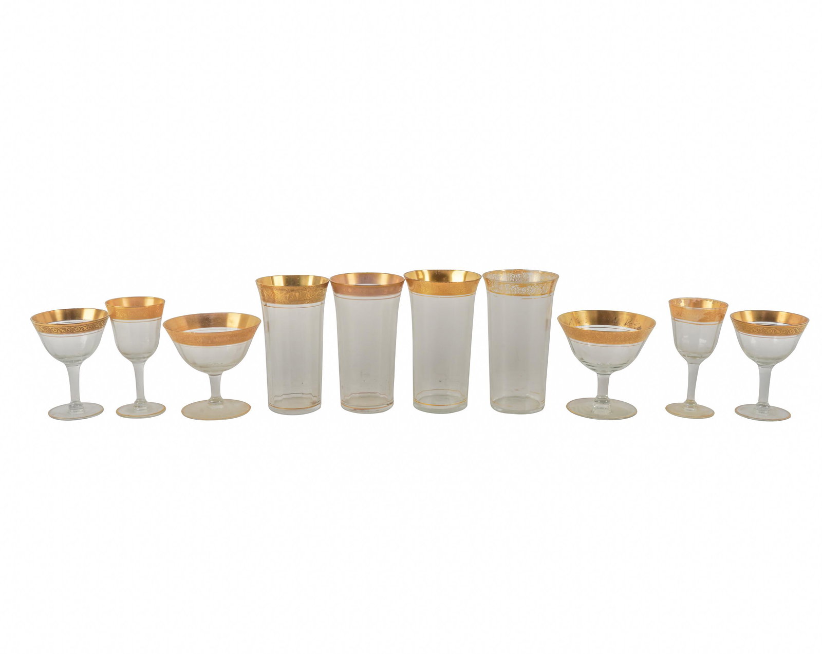 ASSEMBLED GILT GLASS STEMWARE SERVICE: unsigned; an assembled set comprising nine tall tumblers (5 1/2 inches high); four small goblets (4 1/2 inches high); 11 champagne coupes (3 3/4 inches high); 16 dessert wine glasses (4 inches high); 