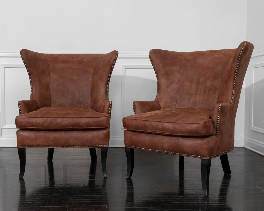 CHRISTIAN AUDIGIER PAIR OF LEATHER WING ARMCHAIRS: With brass tacks and no labels.30 inches wide; 36 inches deep; 41 3/4 inches high; seat height: 20 1/2 inches