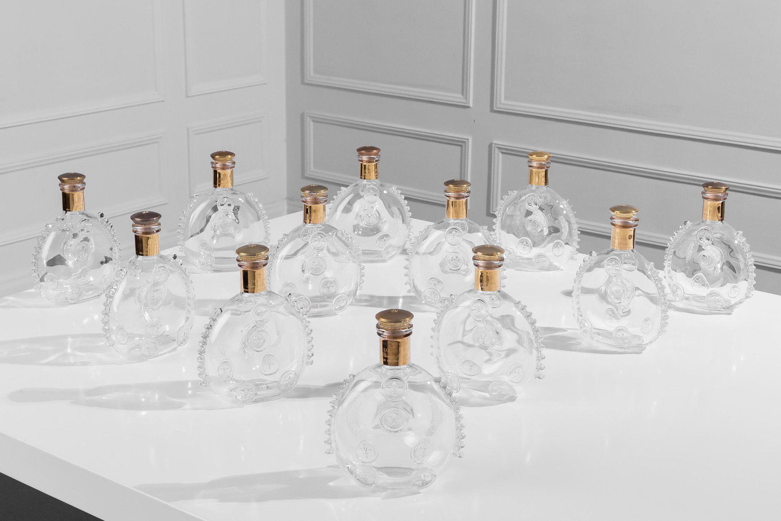 CHRISTIAN AUDIGIER 12 BACCARAT LOUIS XIII BOTTLES: With the metal stoppers.6 1/2 inches wide; 3 inches deep; 8 1/2 inches high