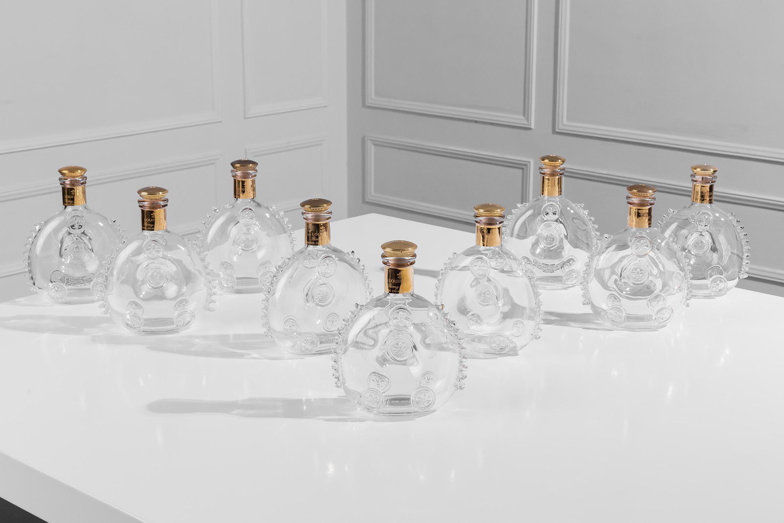 CHRISTIAN AUDIGIER 9 BACCARAT LOUIS XIII BOTTLES: With the metal stoppers.6 1/2 inches wide; 3 inches deep; 8 1/2 inches high
