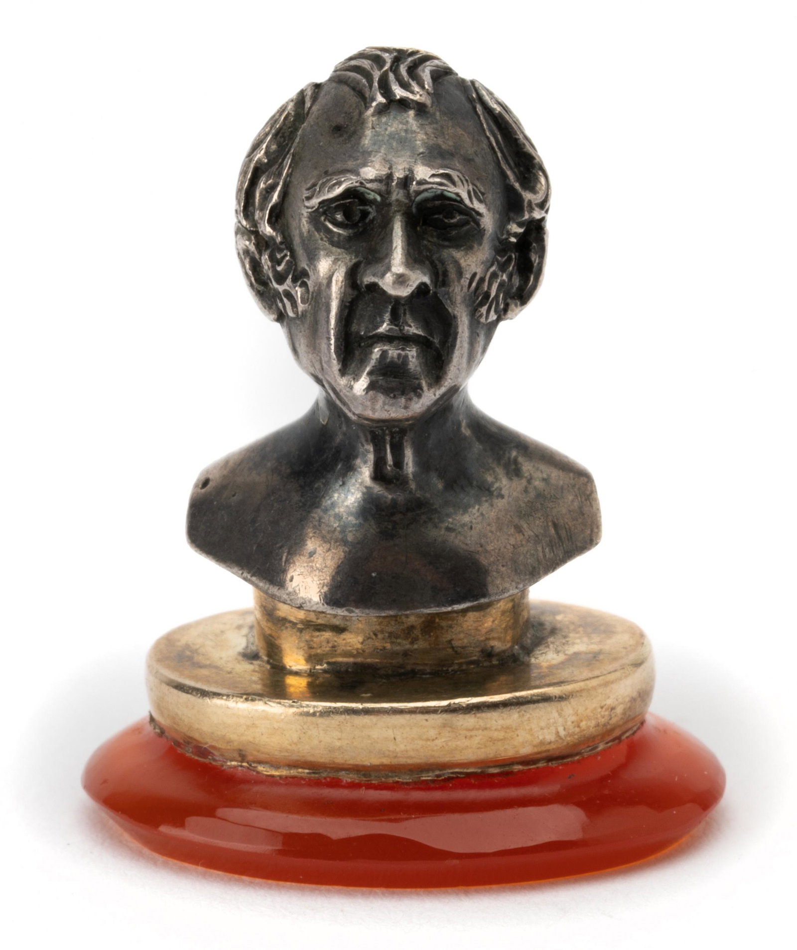14 KARAT YELLOW GOLD, SILVER, & CARNELIAN PENDANT: depicting a man's bust; containing one oval, tablet-cut carnelian measuring approximately 20.00 x 15.80 mm; 11.5 grams; 24.00 mm long