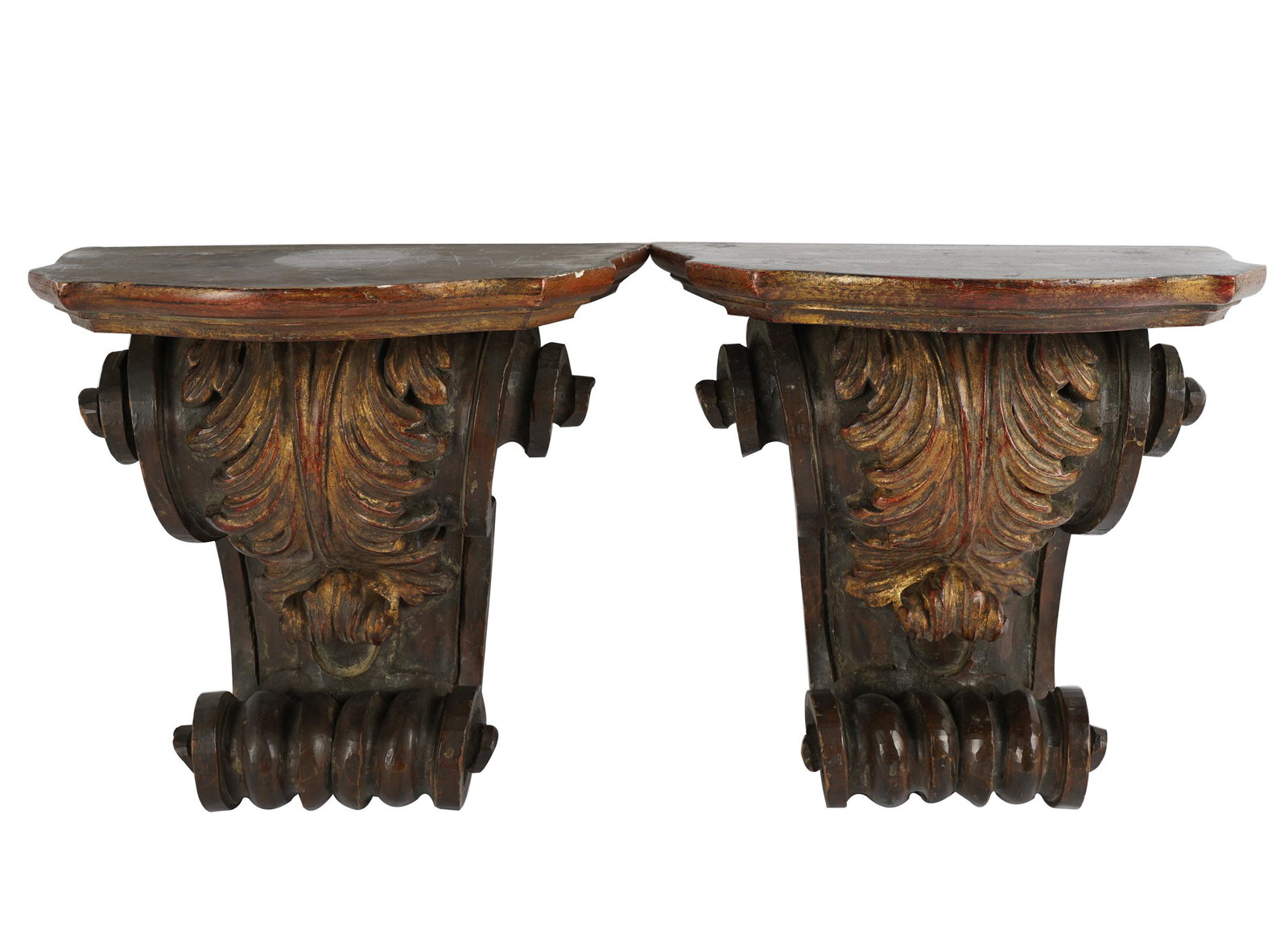 PAIR OF CONTINENTAL CARVED WOOD CORBELS: each with serpentine platform; Condition: only remnants of gilding remaining; 11 1/2 inches wide; 7 1/4 inches deep; 11 inches high