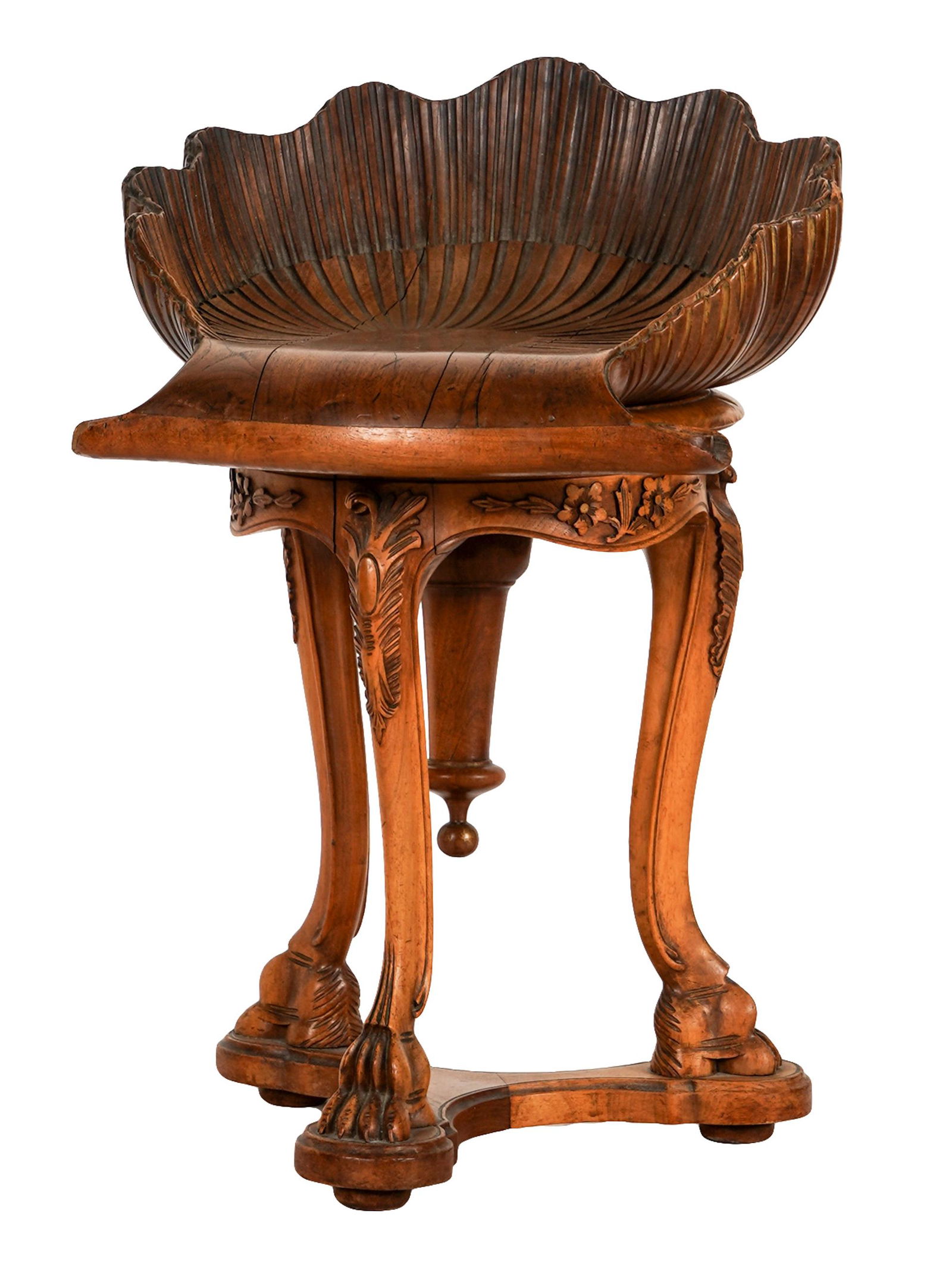 VENETIAN-STYLE CARVED WALNUT GROTTO CHAIR: contemporary; the shell-shaped seat on three legs with claw feet; 17 inches wide; 18 inches deep; 25 1/2 inches high
