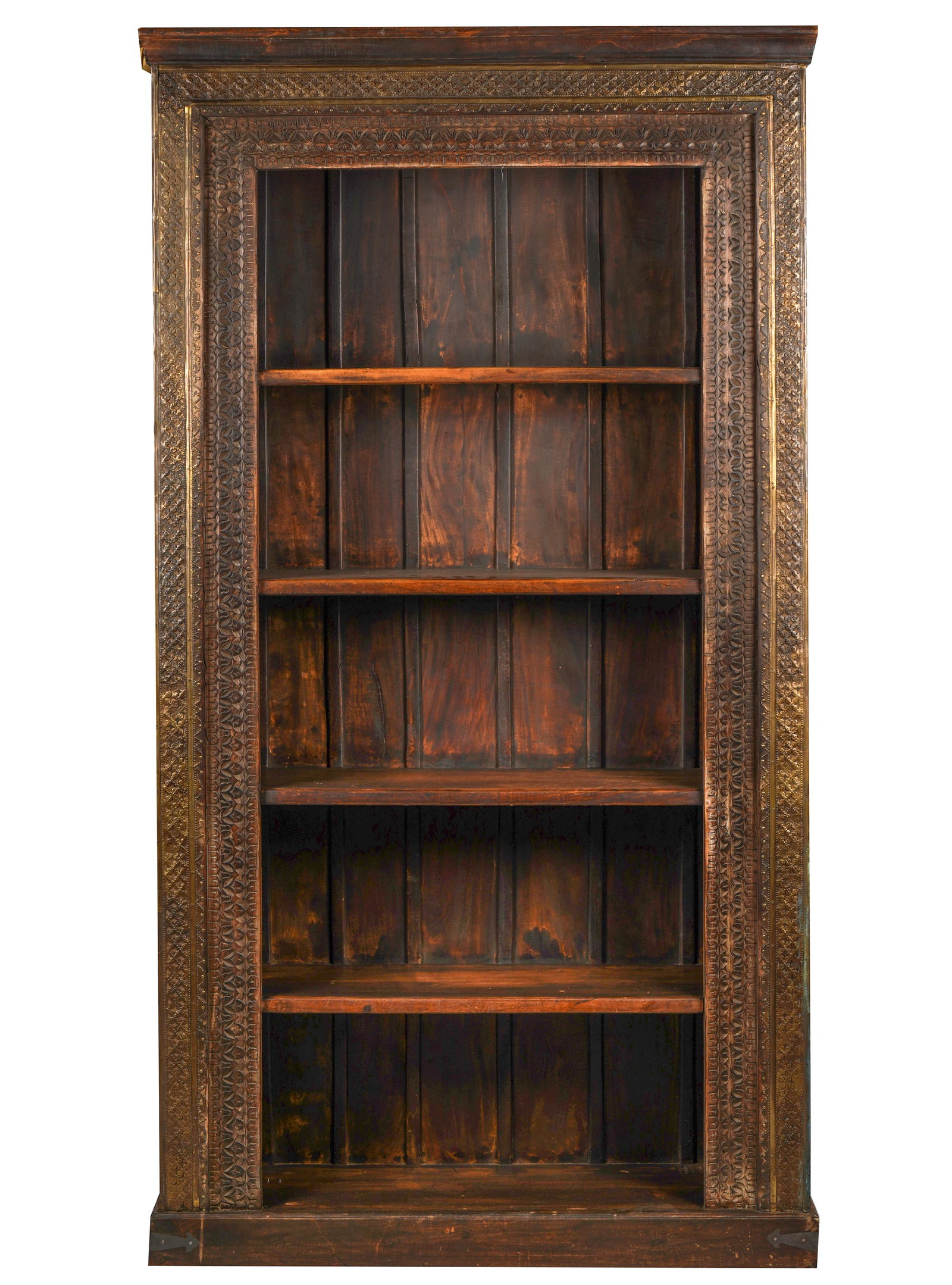 SOUTHEAST ASIAN CARVED MAHOGANY SHELVES: the open front overlaid with strips of patterned brass along top and sides; 52 inches wide; 15 3/4 inches deep; 95 1/2 inches high