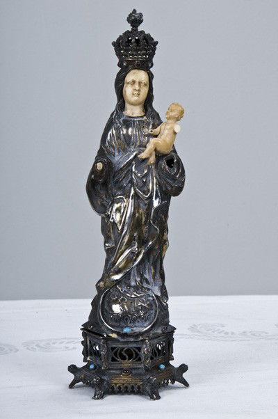 ANTWERP MEDIEVAL STYLE SILVER AND IVORY MADONNA: depicted holding the Christ Child and standing on a hexagonal base with inlaid stones Condition: with some loss of ivory 13 inches high
