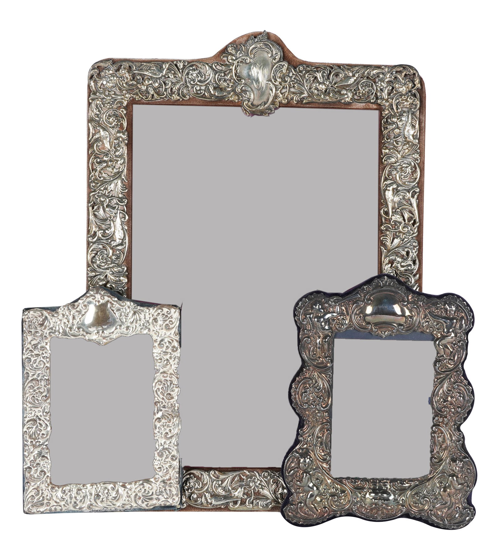 THREE ORNATE STERLING PICTURE FRAMES: the first: Keyford frames LTD, London 1990 (9 1/2 x 7 1/2 inches overall, 5 1/2 x 3 3/4 inches opening ); the second: Dominick and Haff, New York, NY, monogrammed (18 1/2 x 13 inches overall, 14 x 9 1