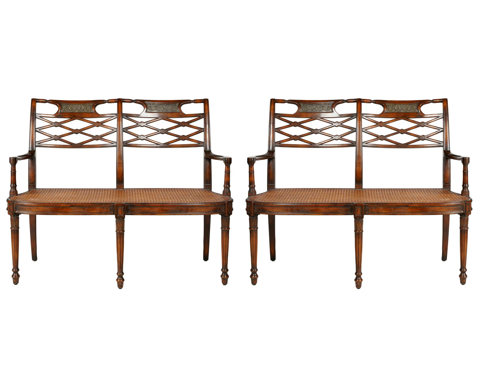 PAIR OF MAHOGANY SETTEES: each backrest inset with a metal plaque; each caned seat fitted with a white linen seat cushion; 50 inches wide; 19 inches deep; 38 inches high; seat height:18 inches