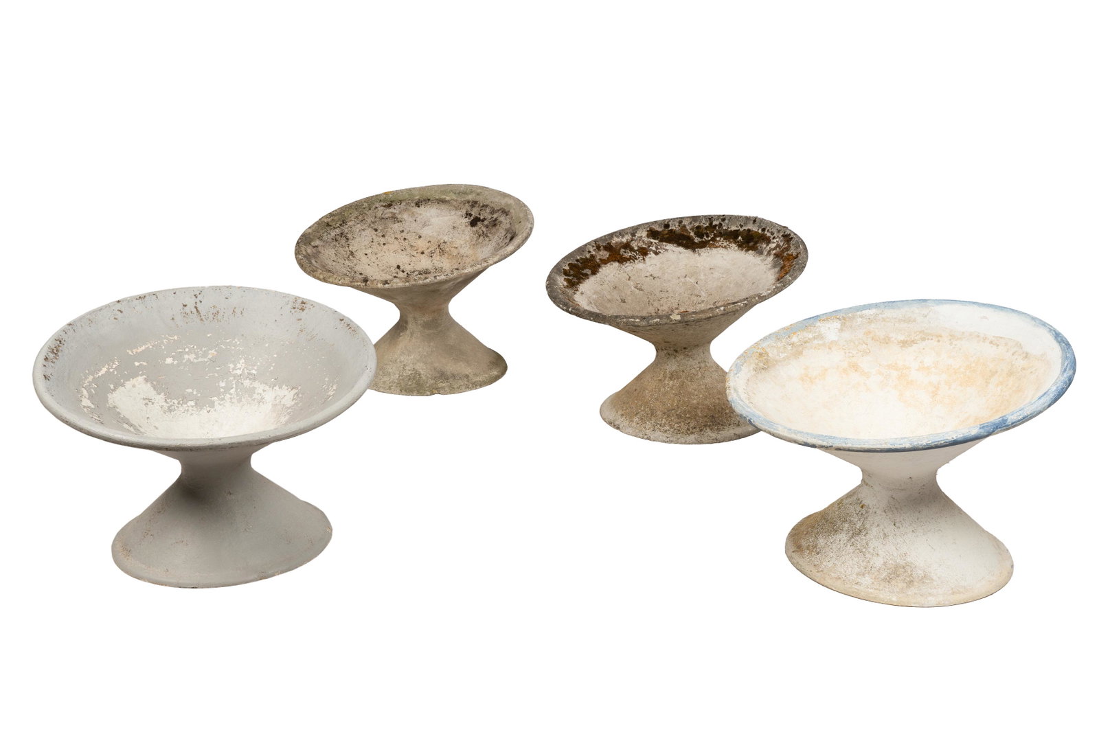 WILLY GUHL (1915 â€“ 2004): FOUR "OFF KILTER" PLANTERS: fibrated concrete; Condition: heavy weathering and wear to each, all drilled; each: 25 inches diameter; 18 inches high