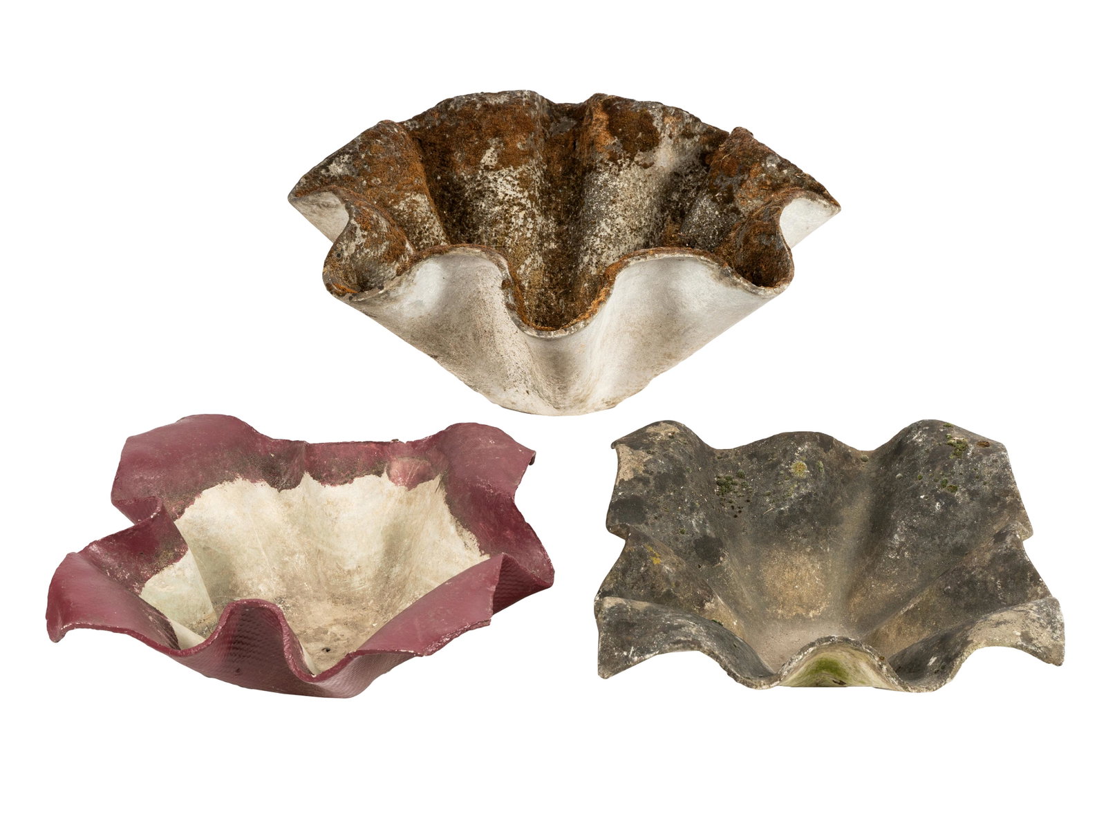 WILLY GUHL (1915 â€“ 2004): THREE TULIP PLANTERS: fibrated concrete; the larger measuring: 31 inches wide; 31 inches deep; 15 inches high; the two smaller: 27 inches wide; 27 inches deep; 8 inches high; Condition: all drilled;
