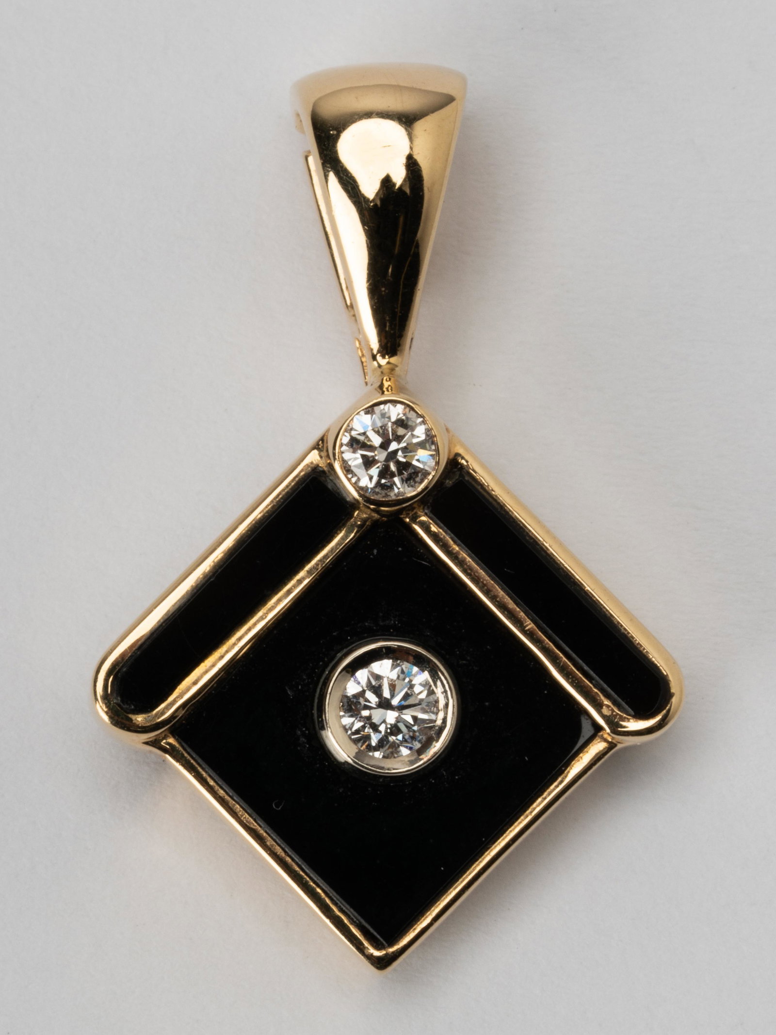 14 KARAT YELLOW GOLD WITH BLACK ENAMEL & DIAMOND PENDANT: Set with two full cut round diamonds [H-J/VS], total weight 0.29 carats; weighs 6.6 grams
