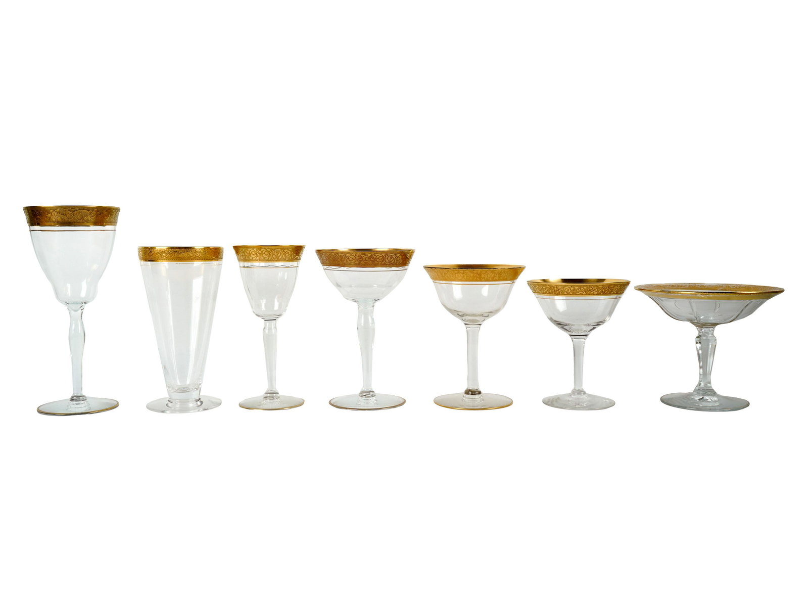ASSEMBLED GILT GLASS STEMWARE SERVICE: unmarked; in at least three different patterns; comprising 30 claret wine glasses (6 1/8 inches high); 28 water goblets (7 1/2 inches high); six wine glasses (6 5/8 inches high); 16 wine glasses (5 7/