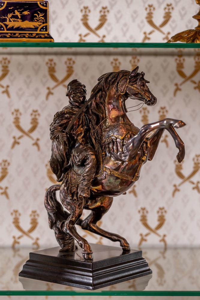 Larry Flynt Silver Horse & Rider: Larry Flynt Silver Horse & Rider affixed to wood base; stamped Magrino and .925 to base; overall 10 1/2 x 9 x 4 1/2 in. (26.67 x 22.86 x 11.43 cm.)