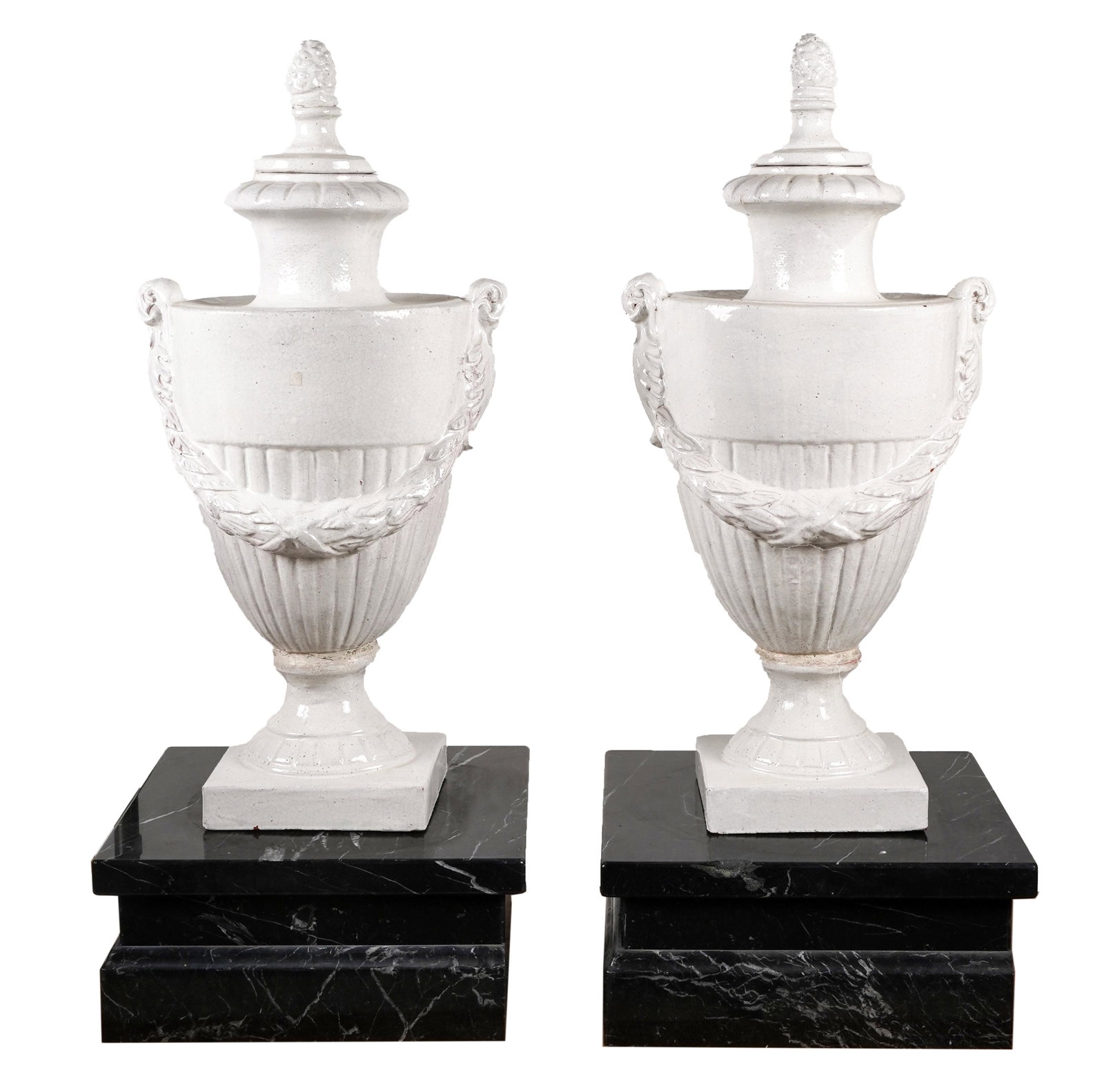 PAIR OF NEOCLASSIC GLAZED TERRACOTTA-COVERED URNS: each with custom square marble base; unsigned; each: 16 inches wide; 13 inches deep; 33 inches high; each stand: 8 inches high