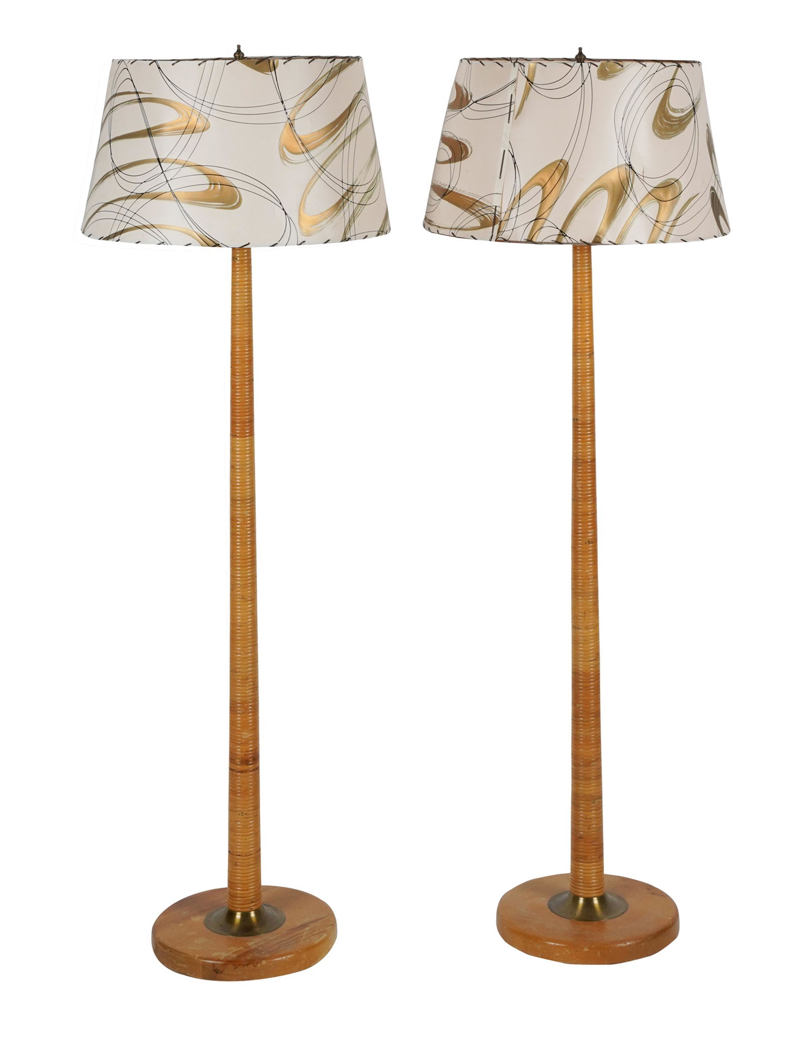 PAIR MID-CENTURY MODERN RATTAN-WRAPPED FLOOR LAMPS: in the style of Russel Wright; each on a brass and blonde wood base; unsigned; Condition: each shade with at least one tear; discoloration to each wooden base; 56 1/2 inches high; shade: 19 inches dia