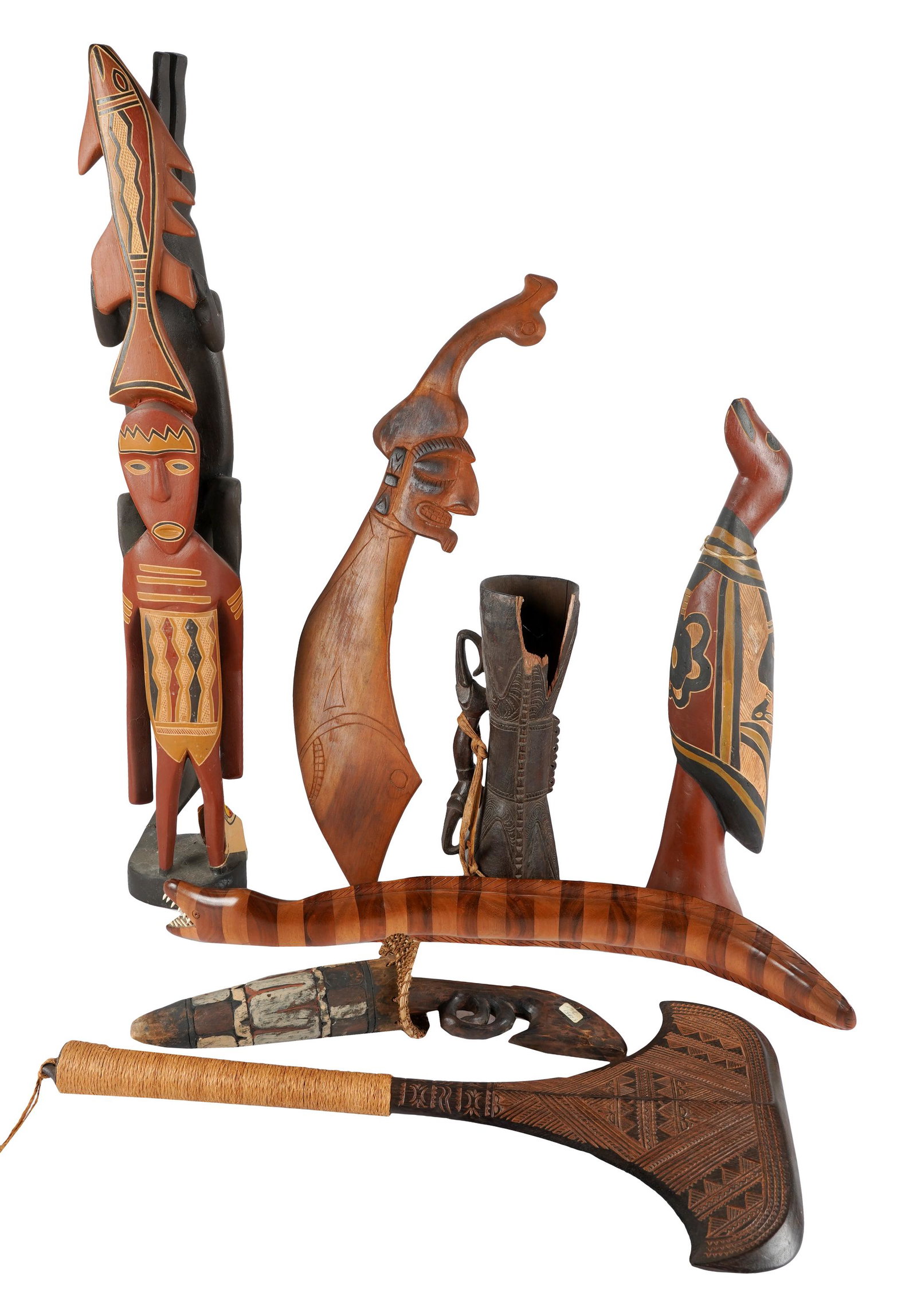 COLLECTION OF PRIMITIVE WOOD CARVINGS: comprising an eel (31 inches wide); double edge weapon (27 1/2 x 13 inches); erotic two piece (19 1/2 inches high); standing bird (25 1/2 inches high); sword (31 1/2 inches wide); handle instrument (1
