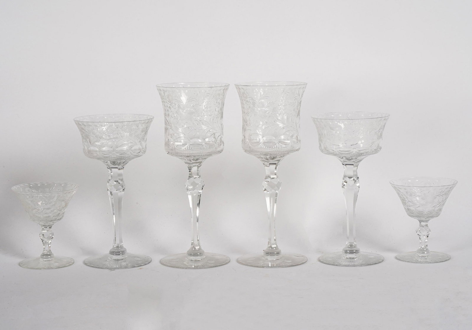 SET OF ETCHED GLASS STEMWARE: comprising: seven wine glasses (7 inches high); eight water glasses (8 1/2 inches high); and five small stems (3 3/4 inches high);