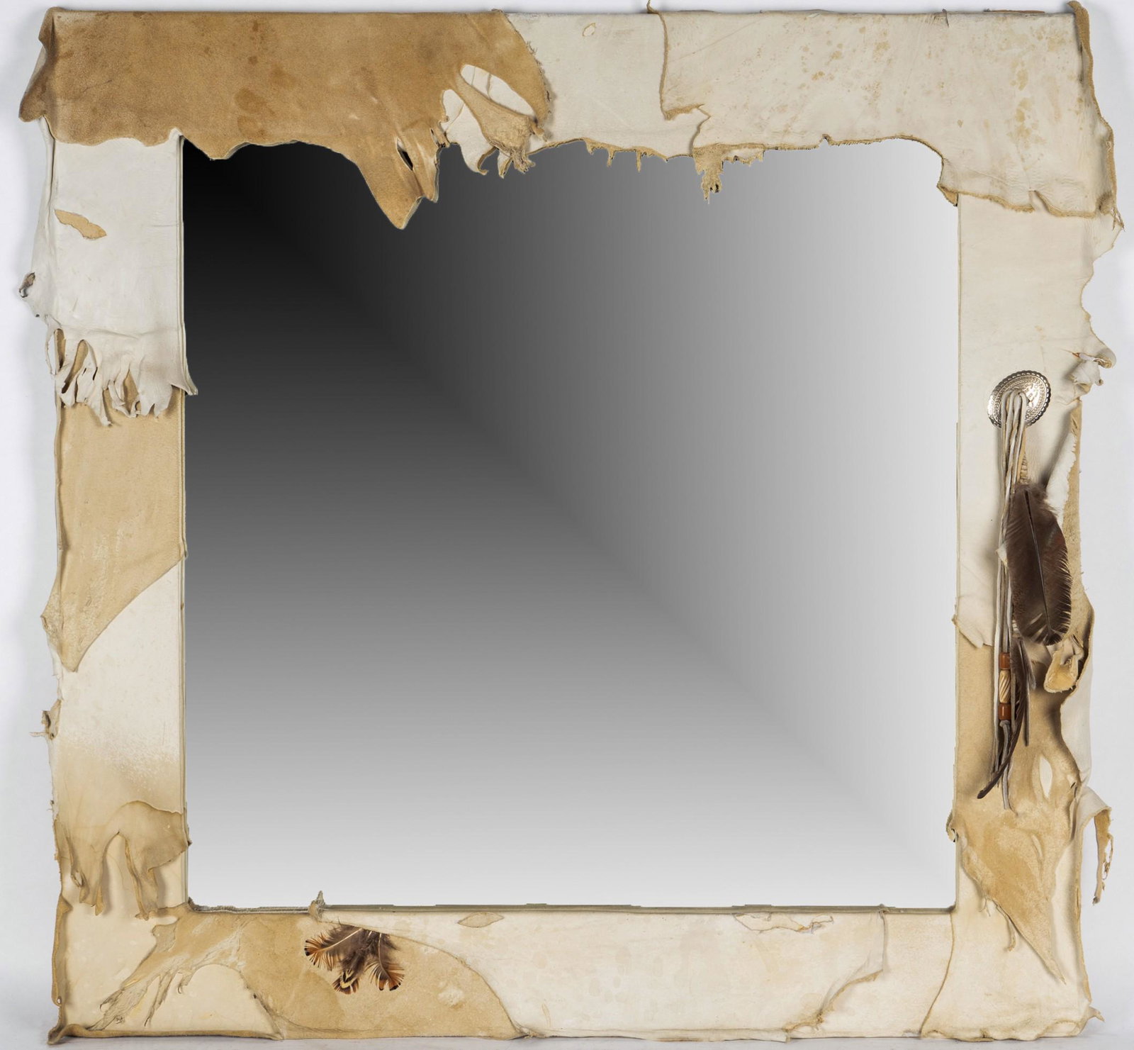 Connie Stevens: Hide-Wrapped Wall Mirror: decorated with beads and feather strands 30 1/4 x 30 1/4 in. (76.8 x 76.8 cm.)