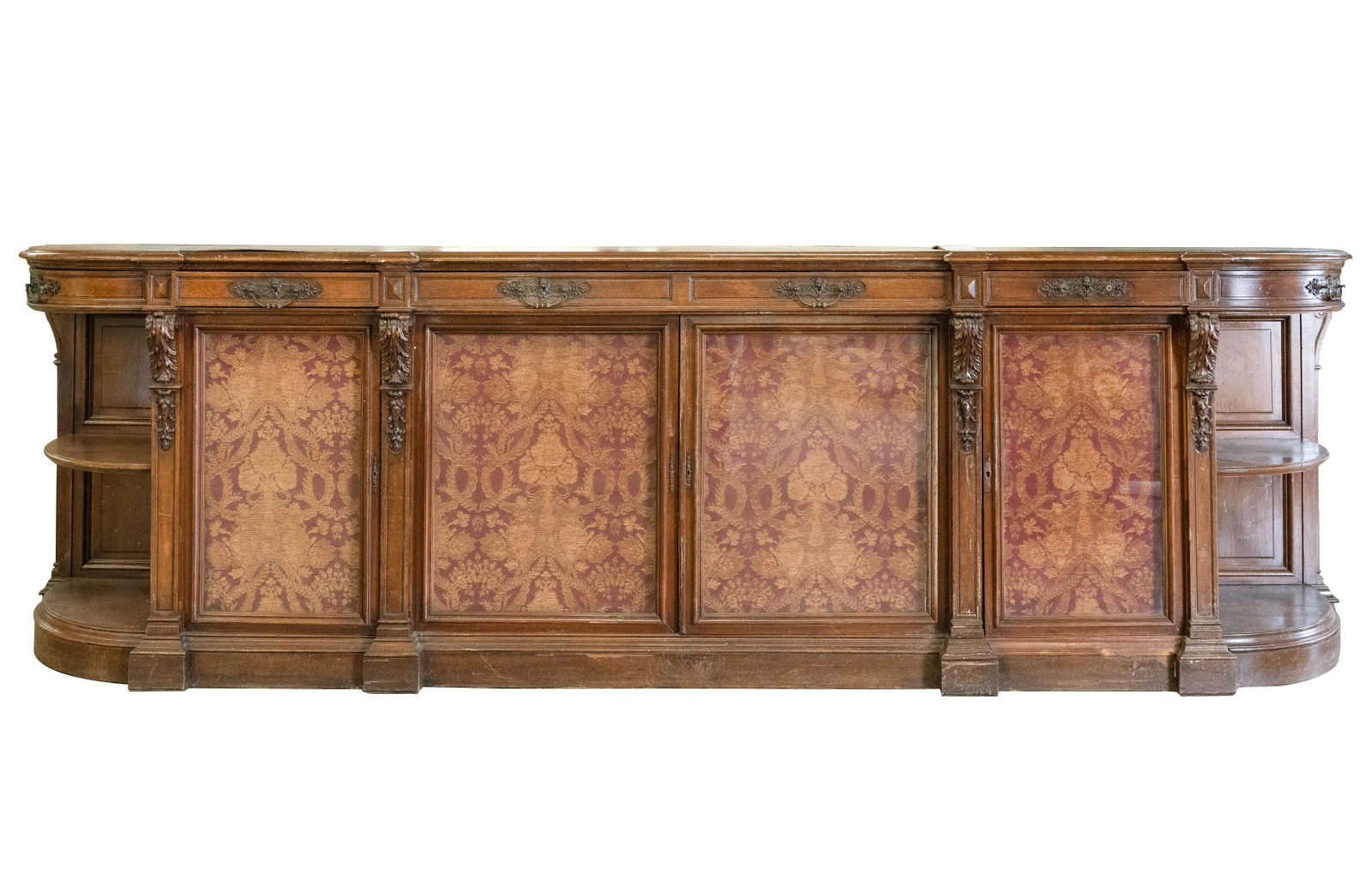 Connie Stevens- Baroque Revival Carved Mahogany Sideboard: late 19th century; the doors inset with fabric 43 1/2 x 148 x 28 1/4 in. (110.5 x 375.9 x 71.8 cm.)