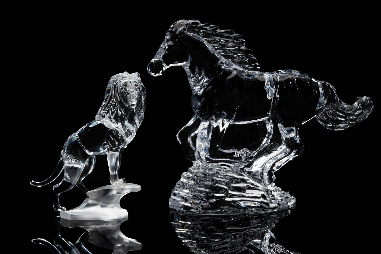 Connie Stevens- Two Crystal Animal Figures: the horse signed "Waterford" to underside, 6 1/4 x 8 1/2 x 3 in. (15.9 x 21.6 x 7.6 cm.), the lion unsigned, 4 3/4 x 4 x 1 3/4 in. (12.1 x 10.2 x 4.4 cm.)