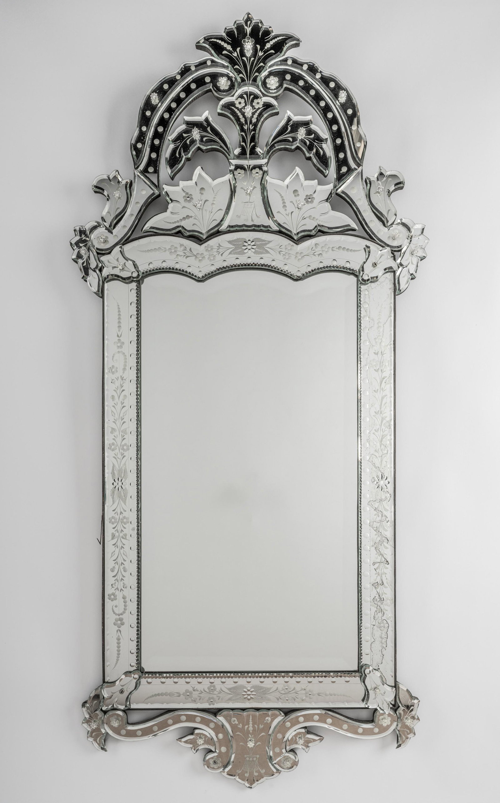 Connie Stevens- Venetian Glass Wall Mirror: the beveled plate within an etched surround 56 x 25 1/2 in. (142.2 x 64.8 cm.)