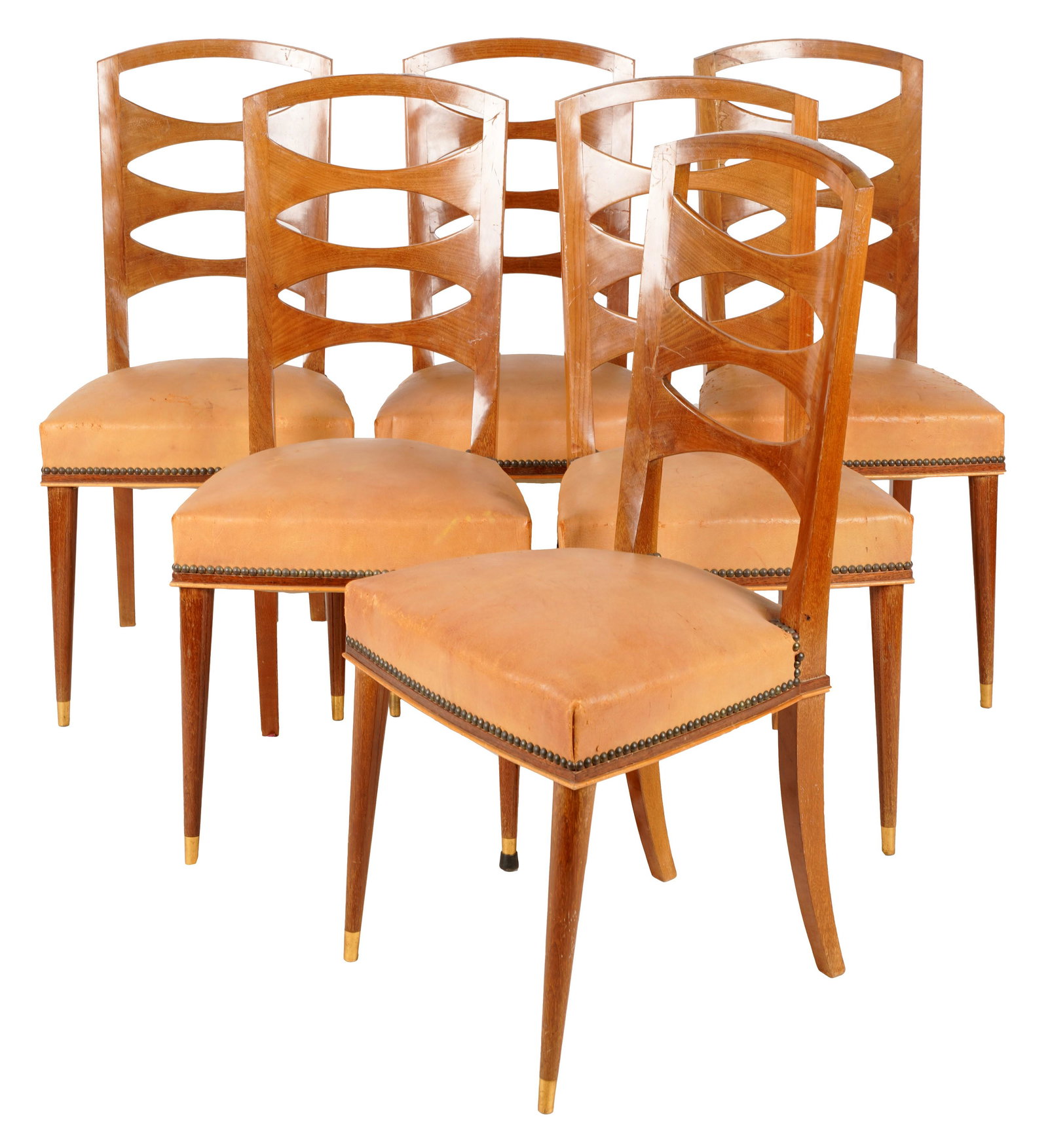 Set of Six Dining Chairs: second or third quarter century; unsigned; the backrests with three ellipsis-shaped cut-outs, the seats covered with tan leather or faux leather with nail head trim, the front feet with brass caps 38 