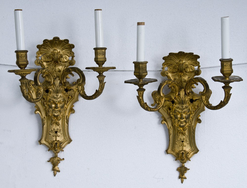 PAIR OF GILT BRONZE TWO-LIGHT SCONCES: in the Louis XVI style; the body with an applied satyr masque and two scrolled candle arms 11 1/2 x 16 12 inches