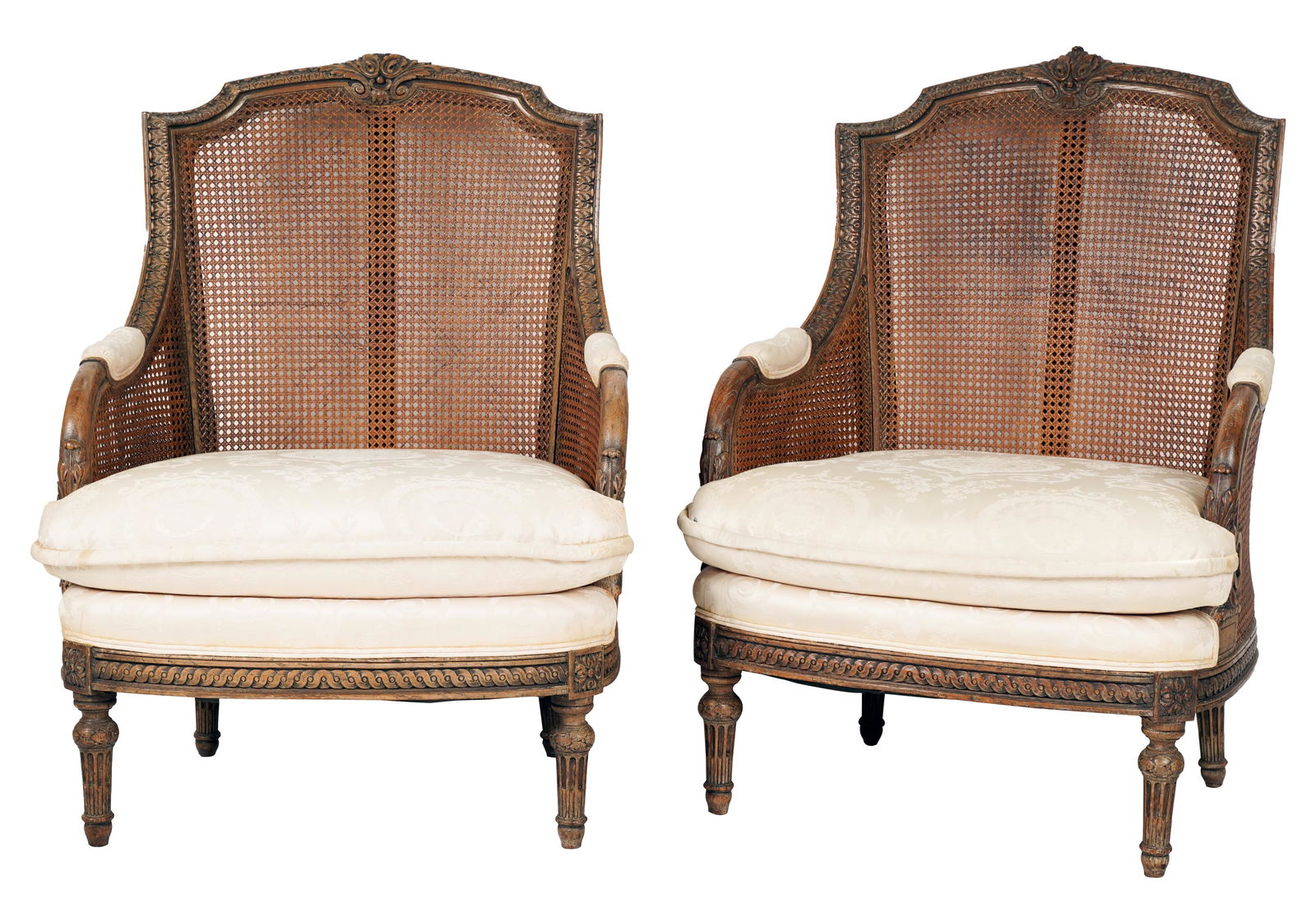 Pair of Neoclassical-Style Caned Bergères: contemporary; unsigned; covered with ivory damask fabric, the armrest supports double-caned 42 1/4 x 30 x 28 in. (107.3 x 76.2 x 71.1 cm.), Seat height: 19 in. (48.3 cm.)