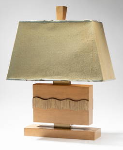 Paul Laszlo (1900-1993): Table Lamp: blonde wood, brass; printed paper label to underside "Laszlo Inc. / Beverly Hills/ Original Design by Paul Laszlo"; with original fabric shade Overall: 26 1/2 x 20 x 10 in. (67.3 x 50.8 x 25.4 cm.); T