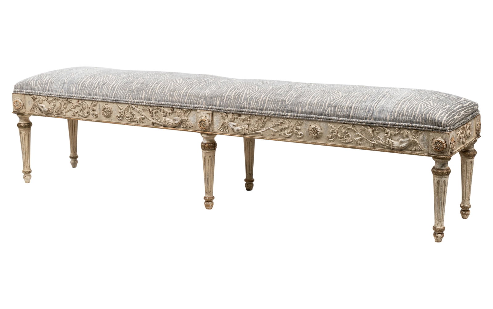 Louis XVI-Style Painted Wood Bench: late 20th century; unsigned; with distressed finish and covered with textured pattern fabric 20 1/2 x 79 x 17 in. (52.1 x 200.7 x 43.2 cm.)