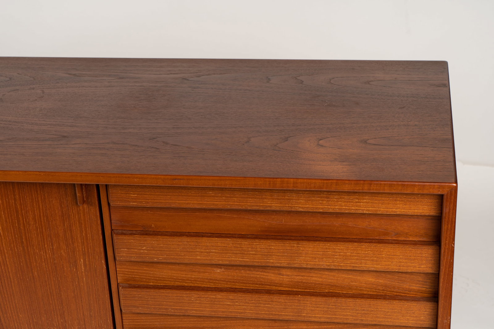Danish Modern-Style Teak Sideboard: manufacturer unknown; with two sliding doors and four drawers 31 1/2 x 82 3/4 x 21 3/4 in. (80 x 210.2 x 55.2 cm.)