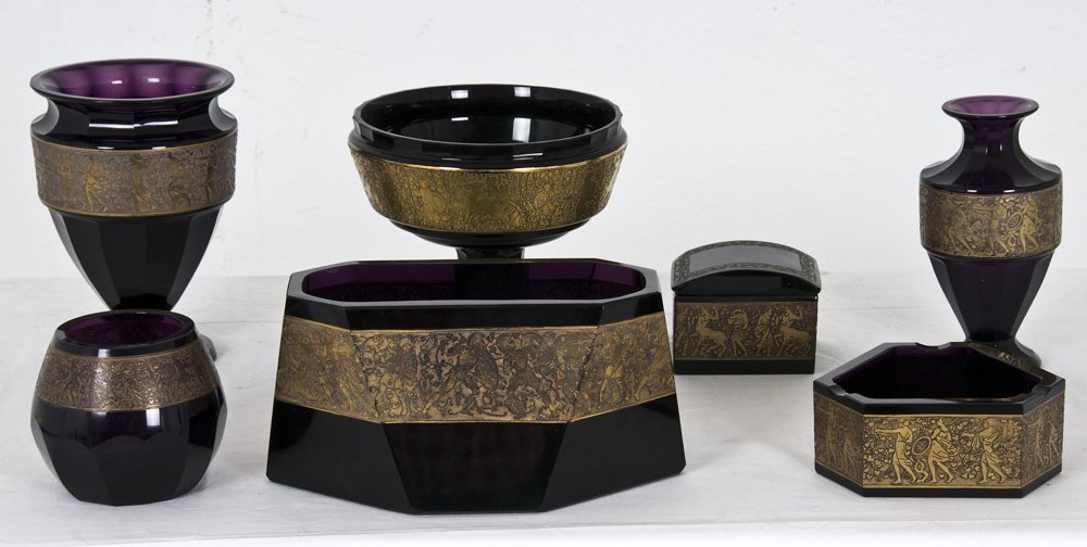 SEVEN MOSER GILT DECORATED AMETHYST CRYSTAL TABLE : comprising of two assorted vases, a rectangular flower bowl, a footed bowl, a covered bowl, an ash tray, and a small vessel