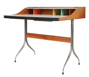 George Nelson (1908-1986): Swag-Leg Desk: model 5850, Herman Miller, Zeeland, Michigan, 1950s; walnut, laminate, chrome-plated steel, lacquered wood, molded plastic; unsigned 34 1/2 x 39 x 29 in. (87.6 x 99.1 x 73.7 cm.) Provenance: Property