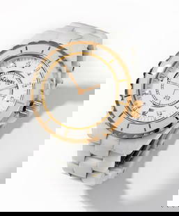 Chanel White Ceramic J12 Quartz Wristwatch: White ceramic wristwatch with stainless steel case and 18 Kt. yellow gold and ceramic bezel, surrounding a 29.00 mm. in diameter round white dial with gold baton shape hour and minute hands, hour posi